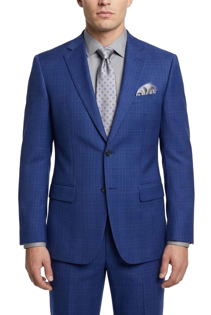 A man wearing a blue plaid suit jacket and matching trousers, styled with a light gray dress shirt, a patterned gray tie, and a matching pocket square, against a plain white background.