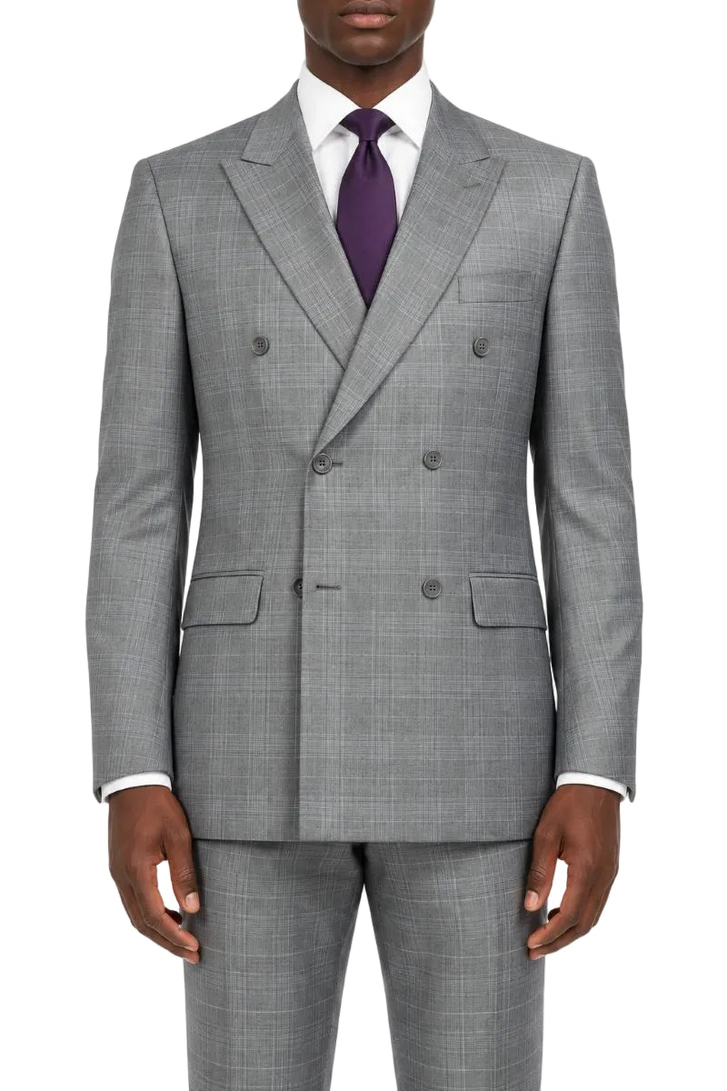 A man wearing a gray double-breasted suit with a subtle windowpane pattern, styled with a white dress shirt and a purple tie, against a plain white background.
