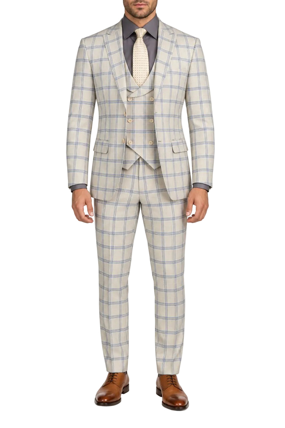A man wearing a light beige and blue windowpane plaid three-piece suit, including a jacket, vest, and trousers, styled with a grey shirt, cream tie, and brown leather dress shoes against a plain white background.