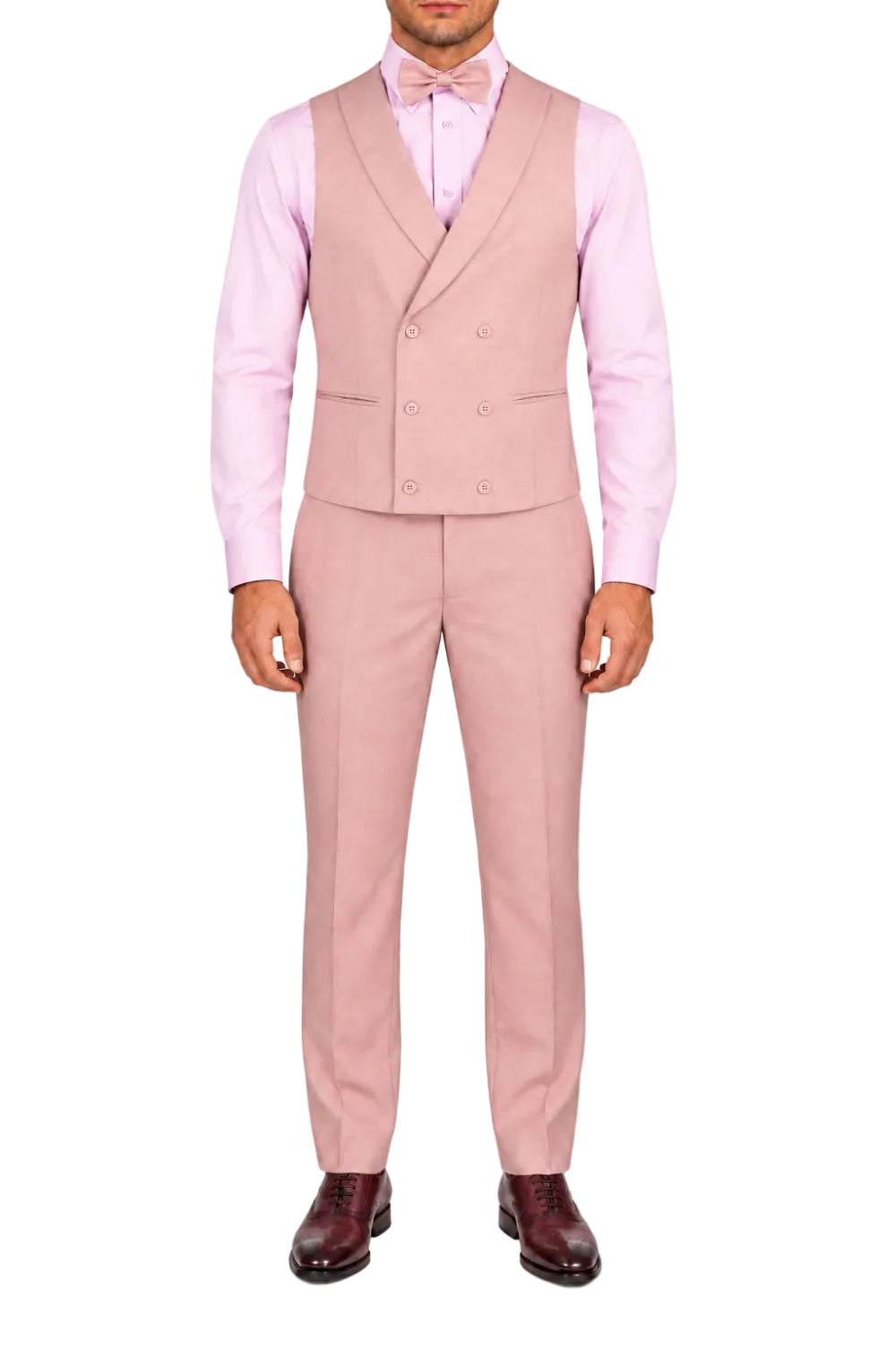 A man wearing a light pink double-breasted suit with a matching pink dress shirt, pink bow tie, and dark brown leather dress shoes, photographed against a plain white background.