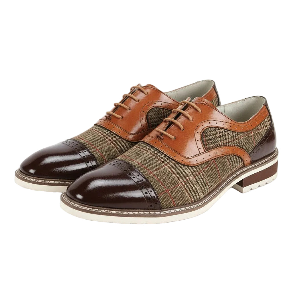 Brown and whiskey dress shoes with patterned toe caps on a white background