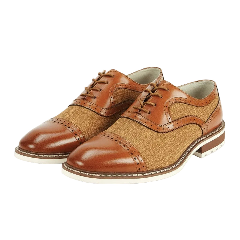 Pair of maple brown leather shoes with a white background