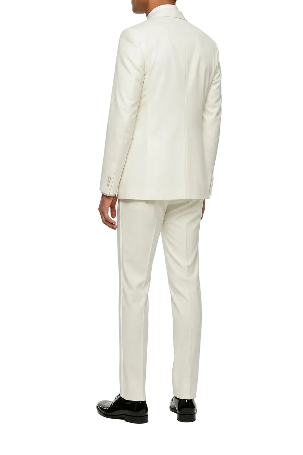 A man viewed from the back wearing a cream-colored two-piece suit with black dress shoes, set against a plain white background.