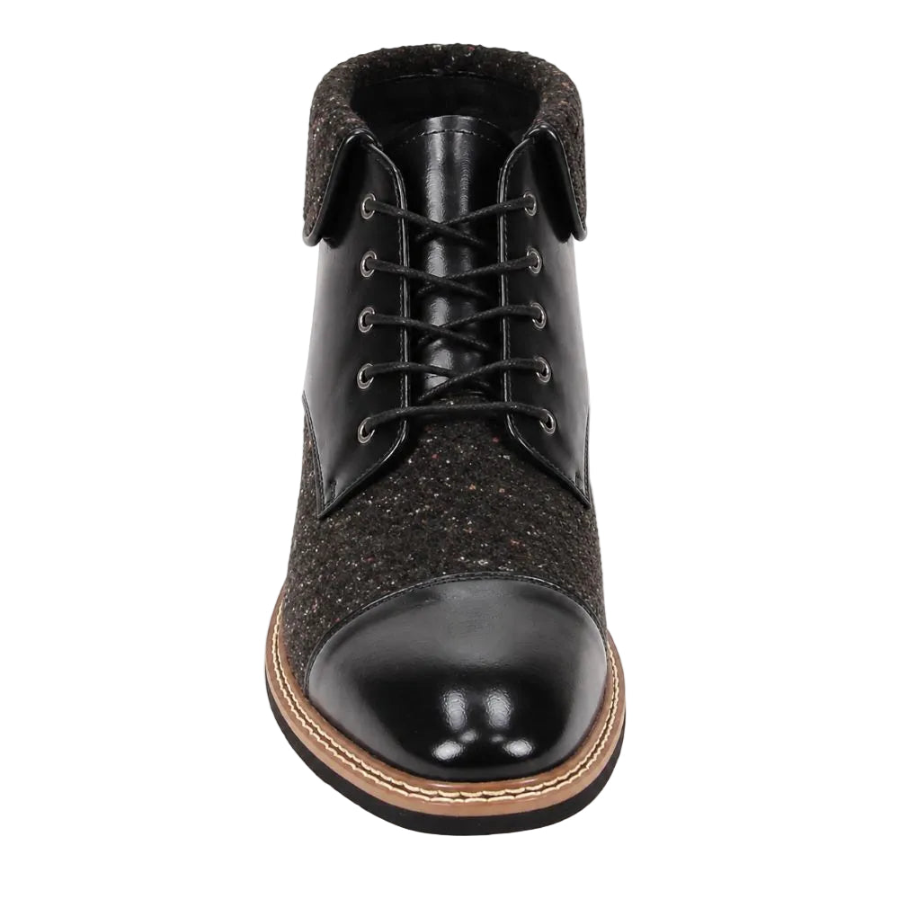 A single black lace-up ankle boot shown from a front-facing overhead angle on a white background. The boot features a glossy black leather toe cap, black leather upper panels, a textured dark brown speckled fabric side, and a tan and black stacked sole.