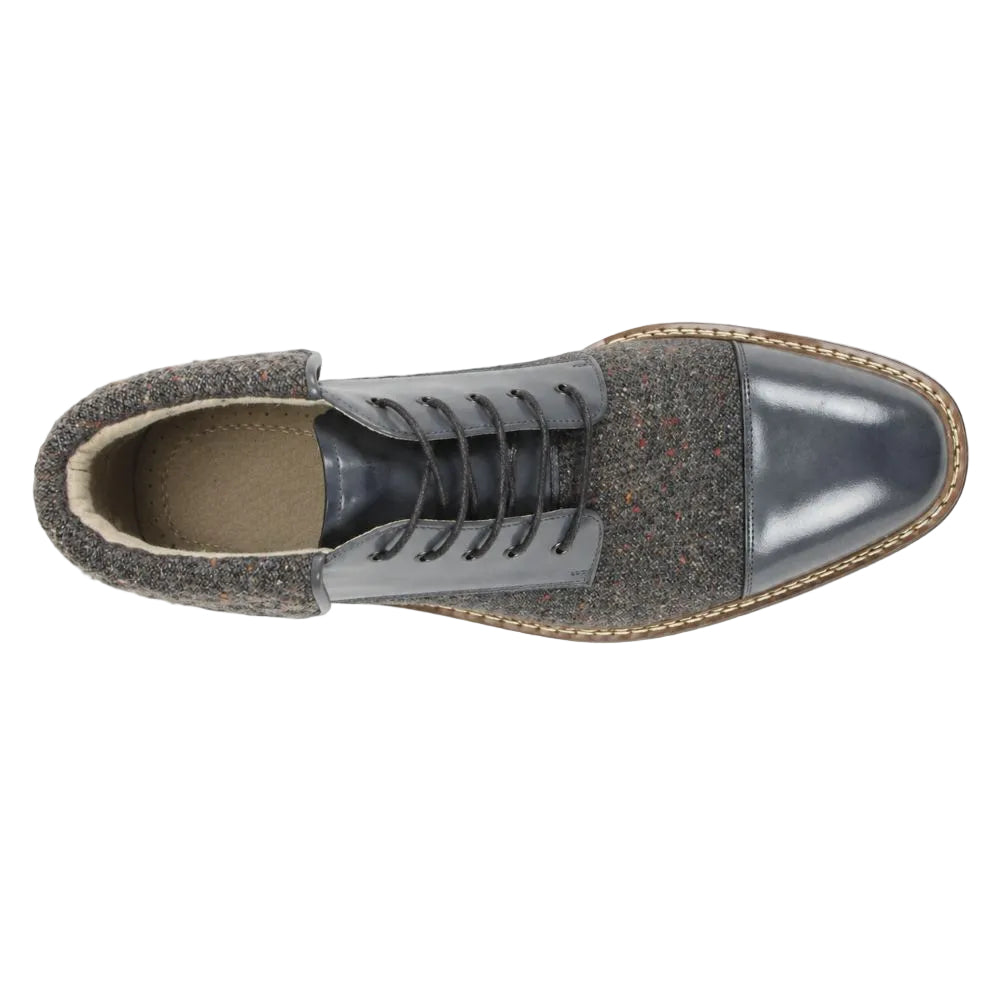 A single men's lace-up ankle boot shown from a top-down view on a white background. The boot features a dark gray leather toe cap, a speckled tweed upper in gray, black, and subtle red flecks, and a tan welted sole.
