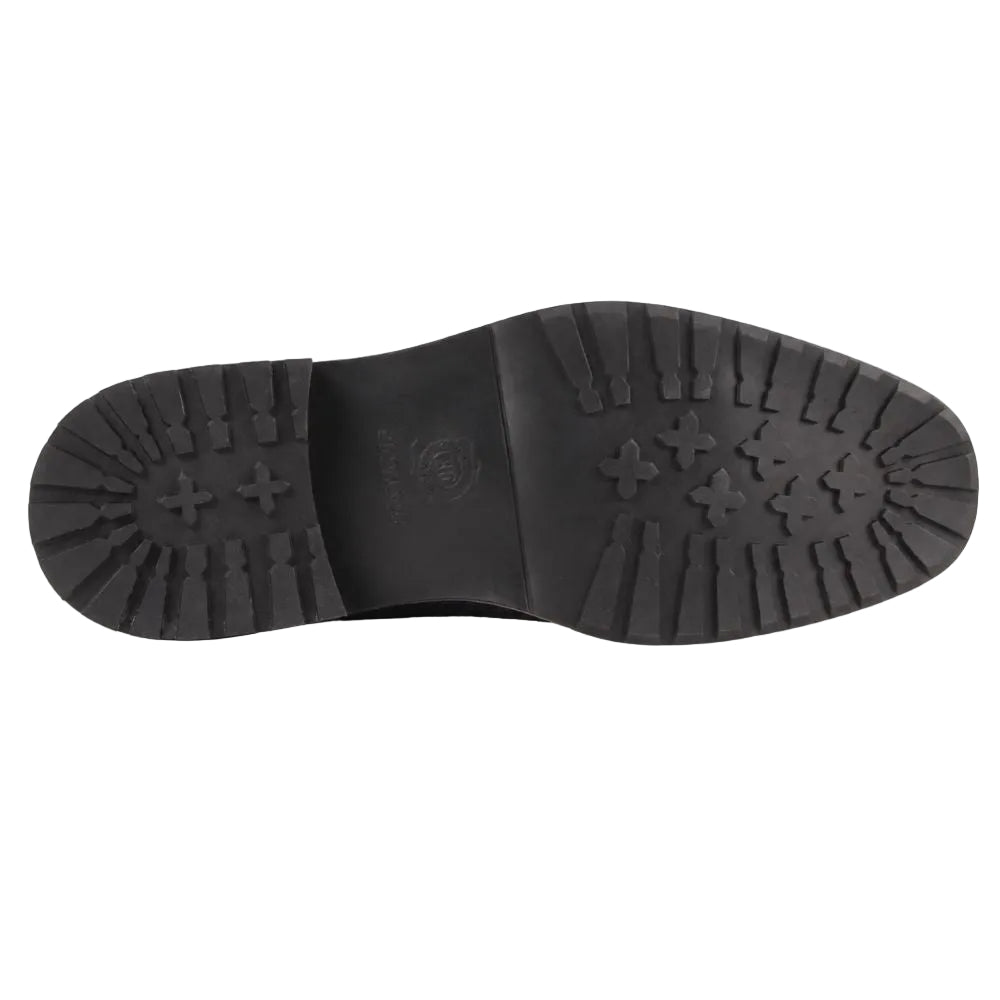 The black rubber outsole of a boot, showing a detailed tread pattern with cross-shaped lugs and a central embossed logo, photographed against a solid white background.