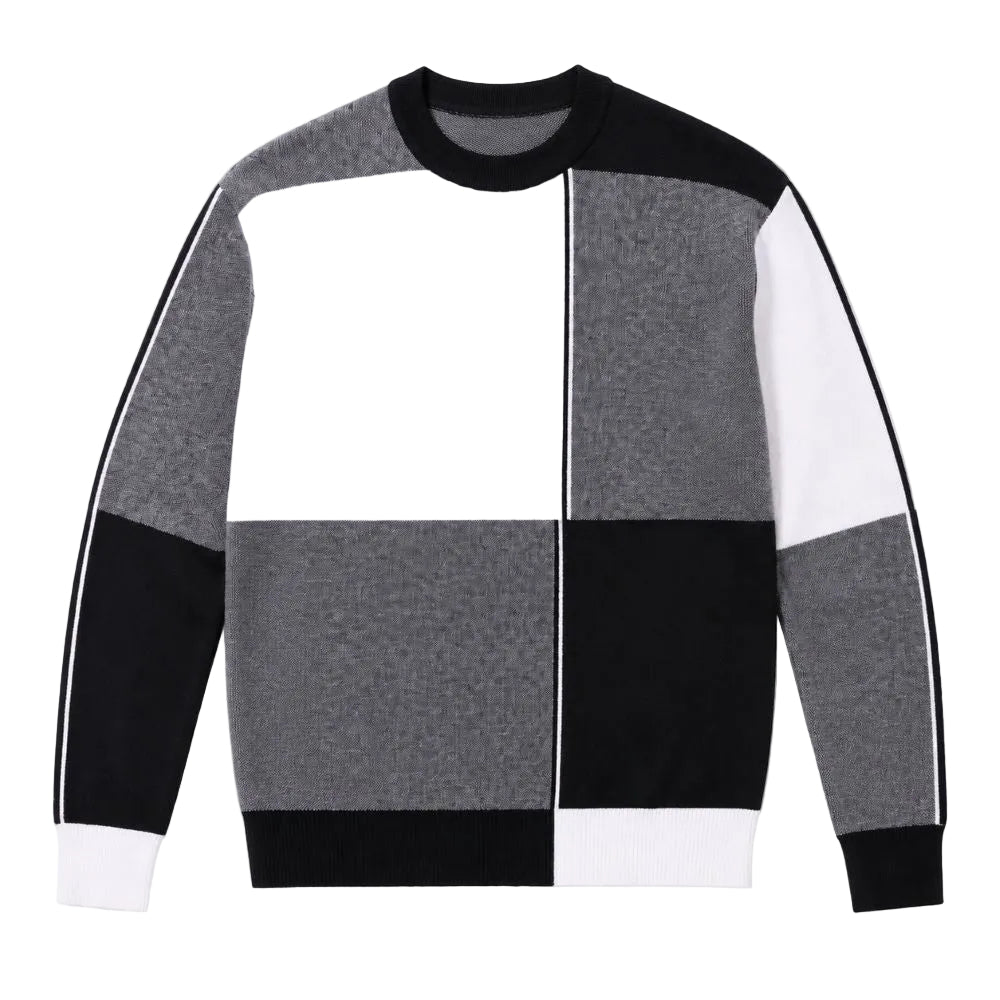 A color-block knit sweater with a geometric patchwork design in black, white, and heather gray, featuring a crew neck and long sleeves with white stripes.
