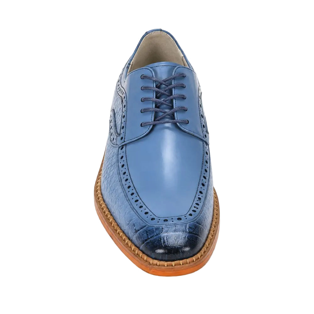 A single men's oxford shoe shown from a top-down front angle on a clean white background. The shoe features a light blue leather upper with a darker blue crocodile-embossed pattern on the toe cap, matching blue laces, and a brown stacked leather sole.