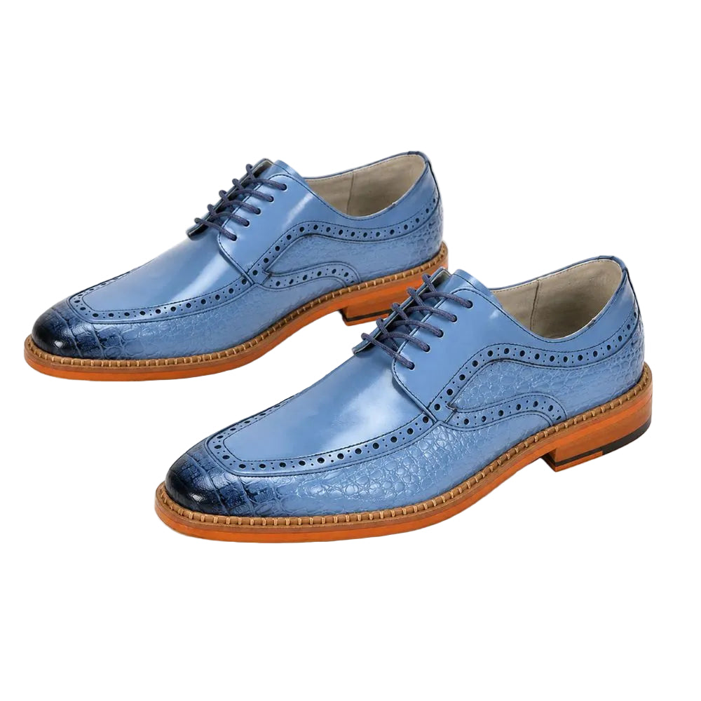 A pair of men's blue leather wingtip oxford shoes with brogue detailing, dark laces, and a tan welt and outsole, shown on a white background.