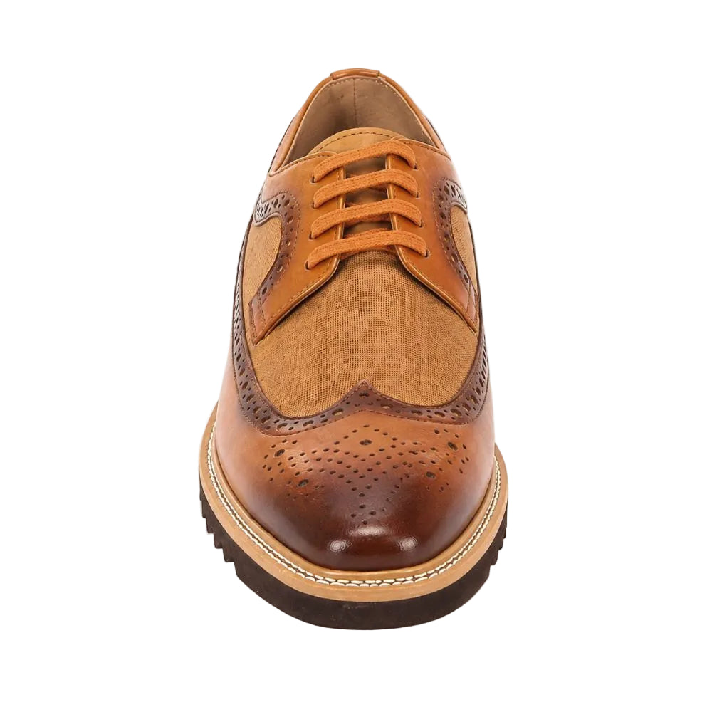 A men's wingtip oxford shoe featuring a mix of smooth tan leather, textured canvas-like fabric panels, and dark brown brogue detailing, shown from a front-facing perspective on a white background.