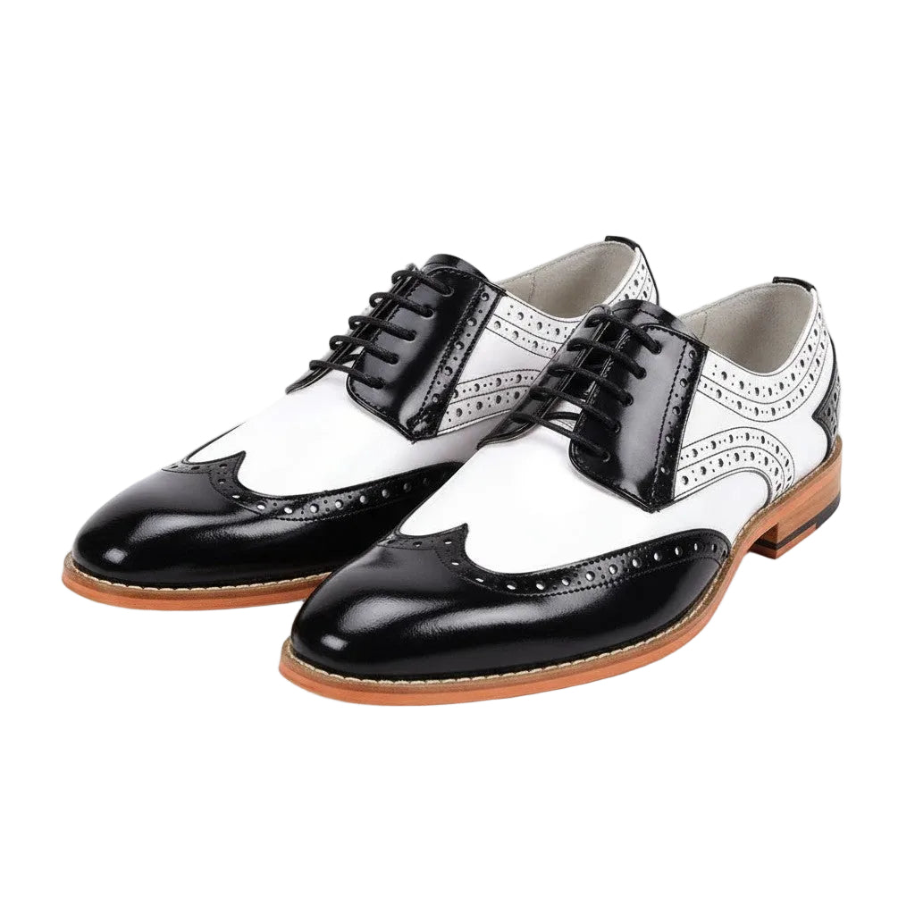 Black and white dress shoes with brown soles on a white background