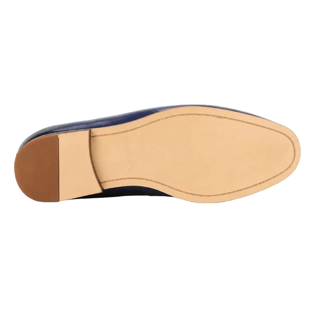 The underside of a navy blue leather shoe, showing a tan leather footbed and a brown heel cap, photographed on a clean white background.