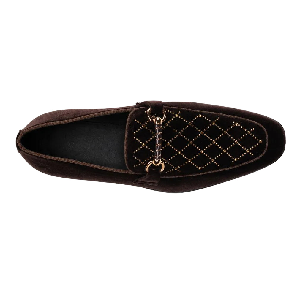 A dark brown velvet loafer with a quilted diamond pattern on the vamp, accented by gold-tone studs and a decorative chain detail, shown from a top-down view on a white background.