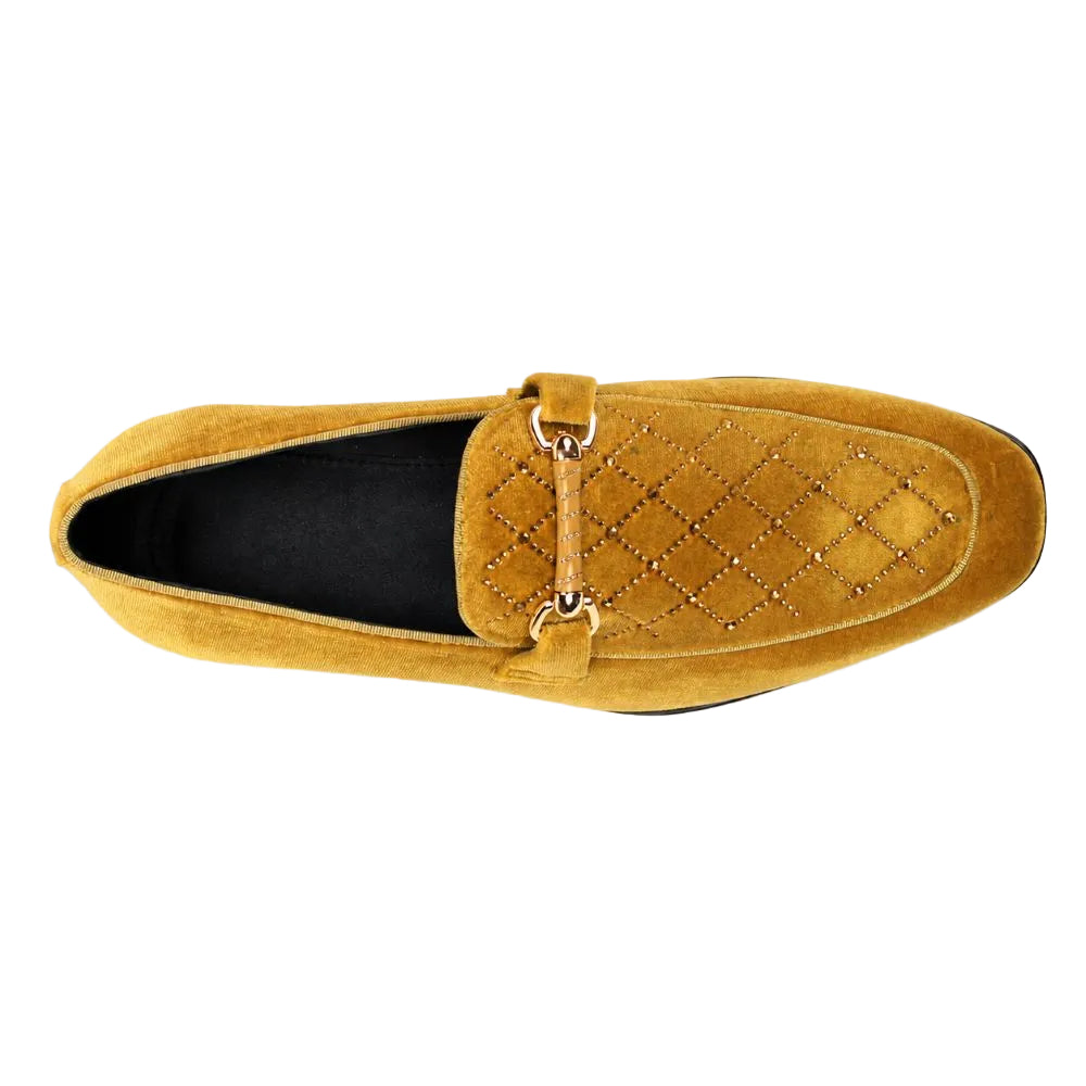 A single men's loafers in mustard yellow suede, featuring a quilted diamond pattern on the vamp with small metallic studs, a matching leather strap with a gold-tone ring, and a black interior lining, shown from a top-down perspective on a white background.