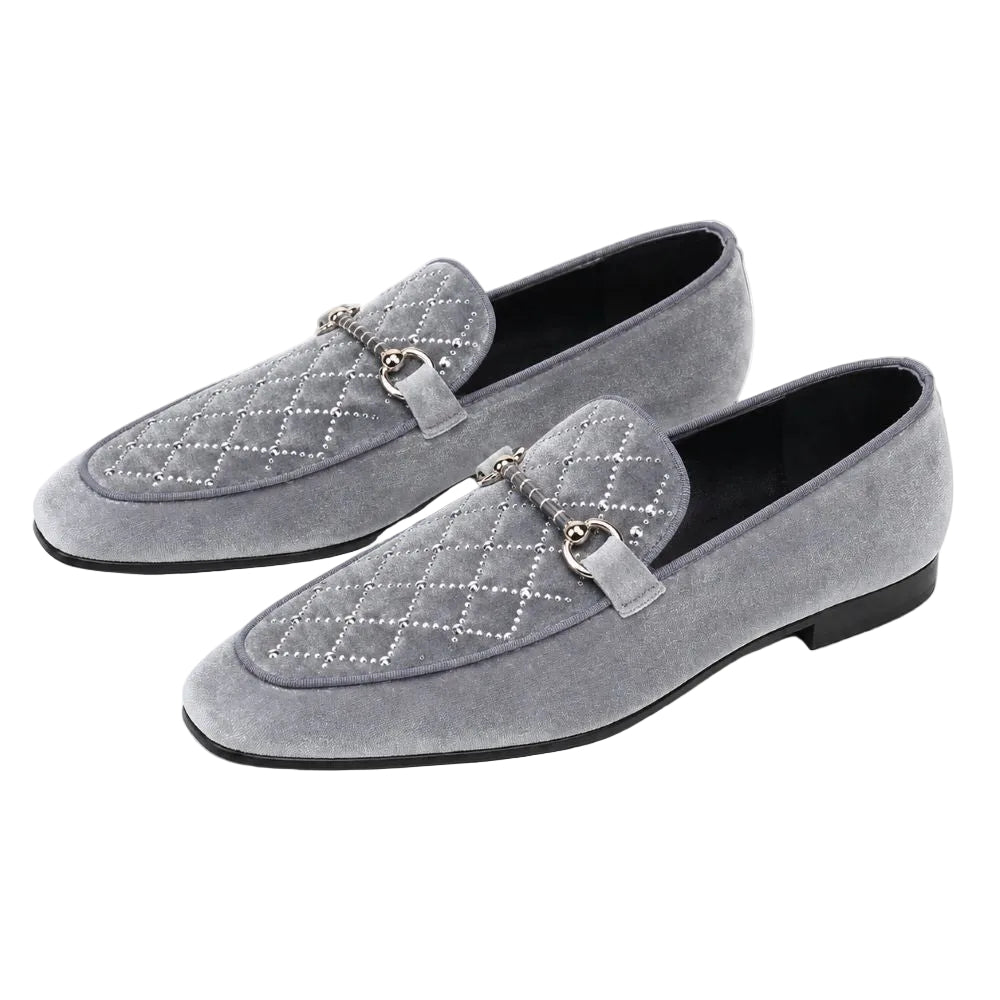 A pair of gray suede loafers with quilted diamond stitching, silver-tone horsebit straps, and silver rhinestone detailing on the toe, shown against a plain white background.