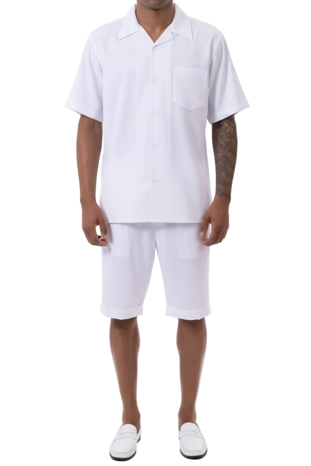 Person wearing a white polo shirt and shorts set on a white background