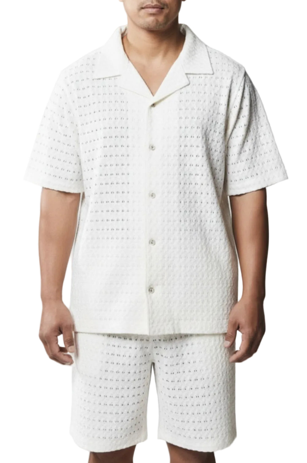 Person wearing a white textured shirt and shorts set on a gray background