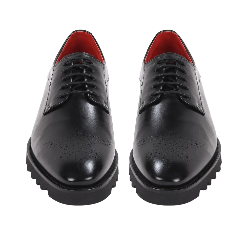 A pair of black leather oxford shoes with brogue detailing, black laces, and a contrasting bright red interior lining, shown from a front-facing perspective on a white background.