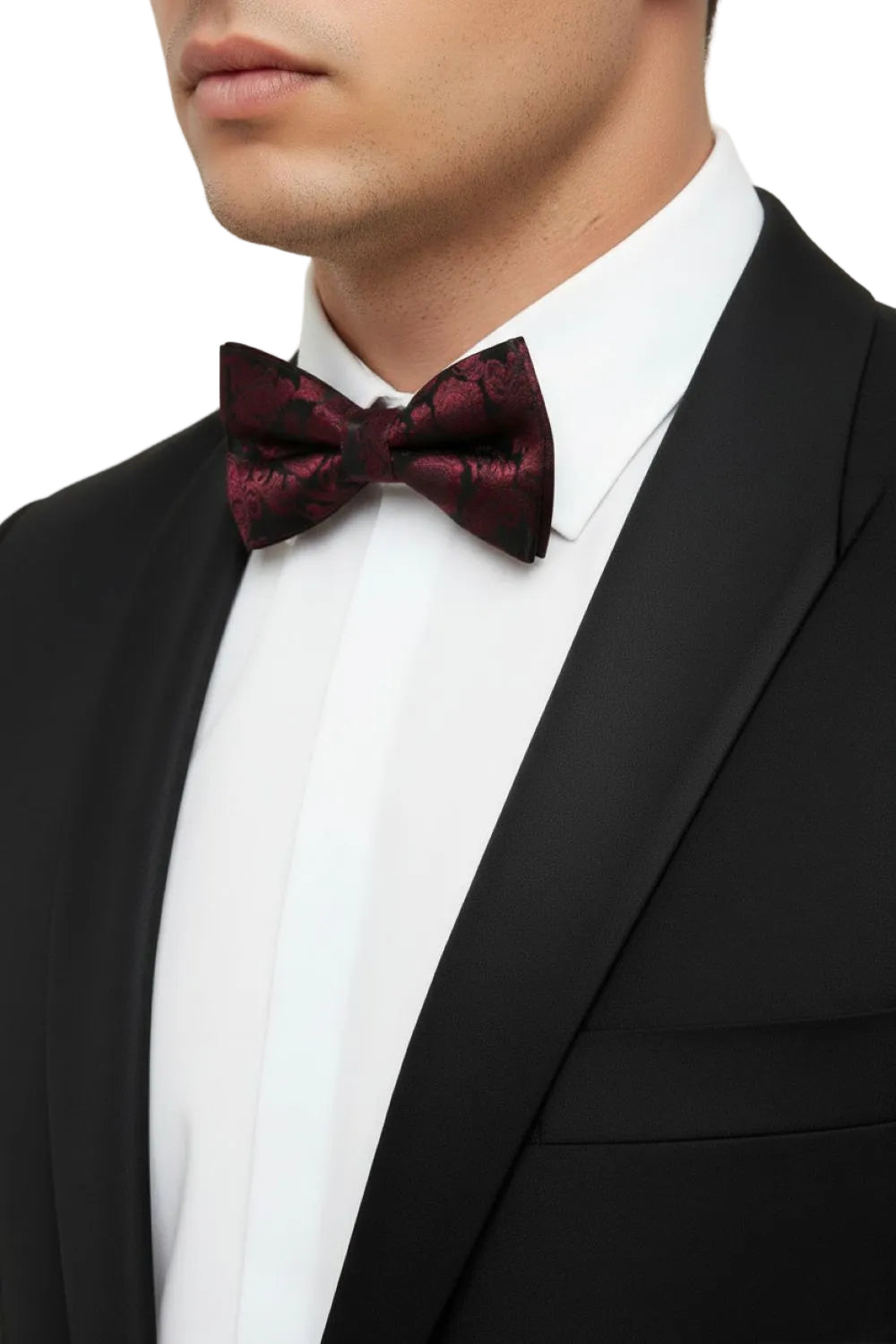 Man wearing a black tuxedo with a burgundy bow tie against a white background
