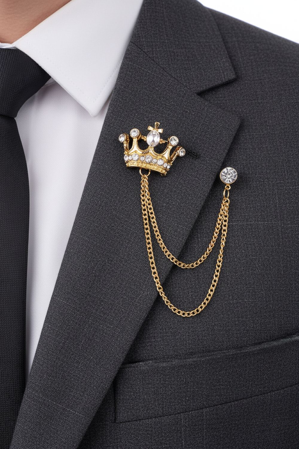 Gold crown brooch with chains on a gray suit jacket