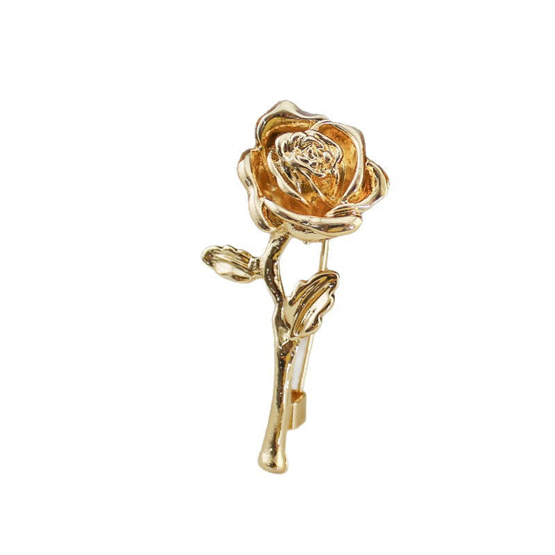 Gold rose-shaped lapel pin on a white background
