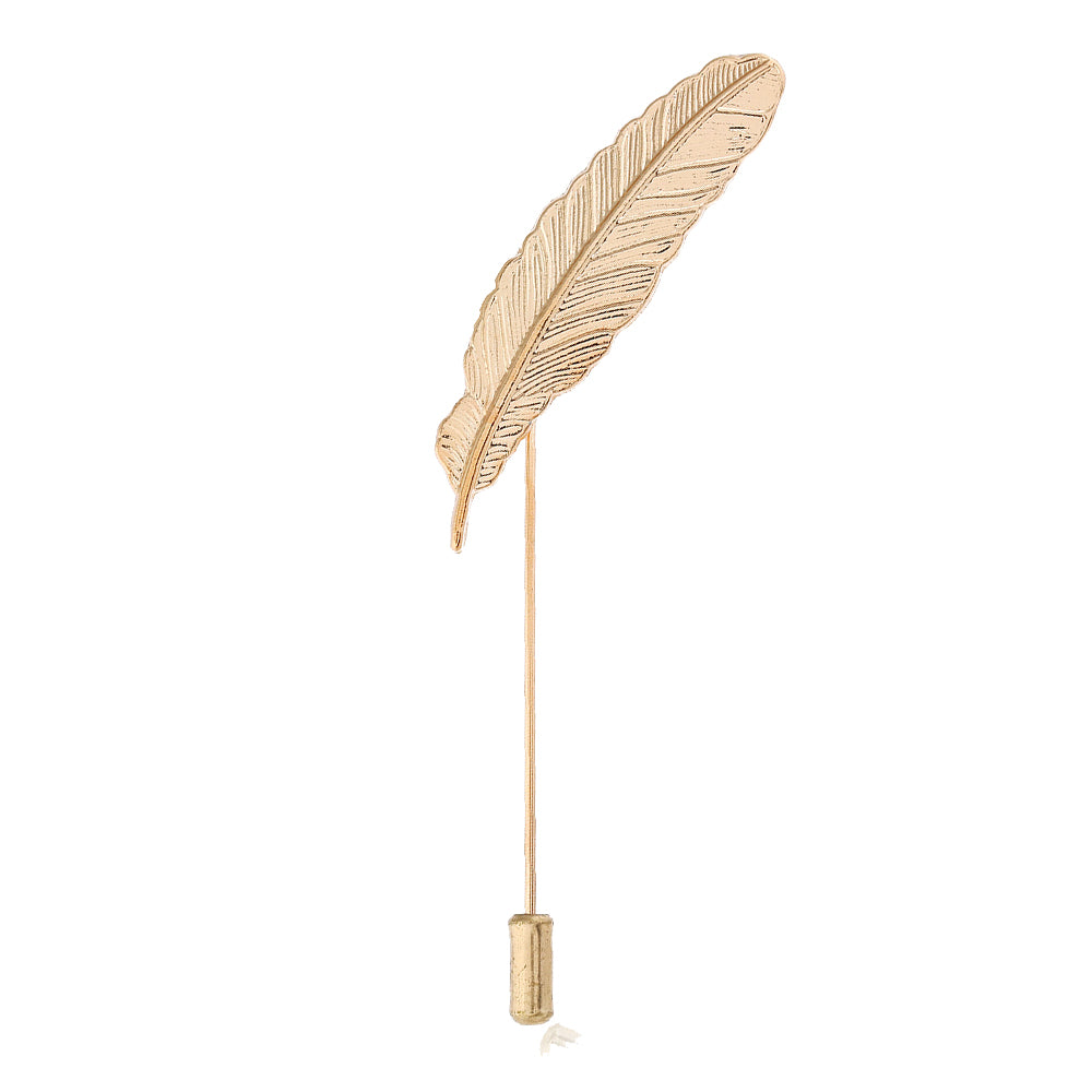 Gold feather-shaped brooch on a white background